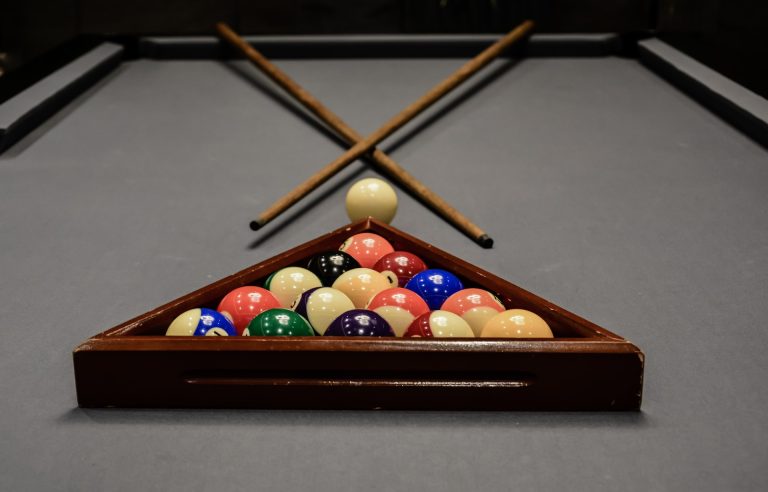 billiard table cue balls by marcelo leal unsplash